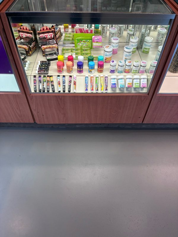 Close-up of a lit glass display case at WeedMart in Irving, NY